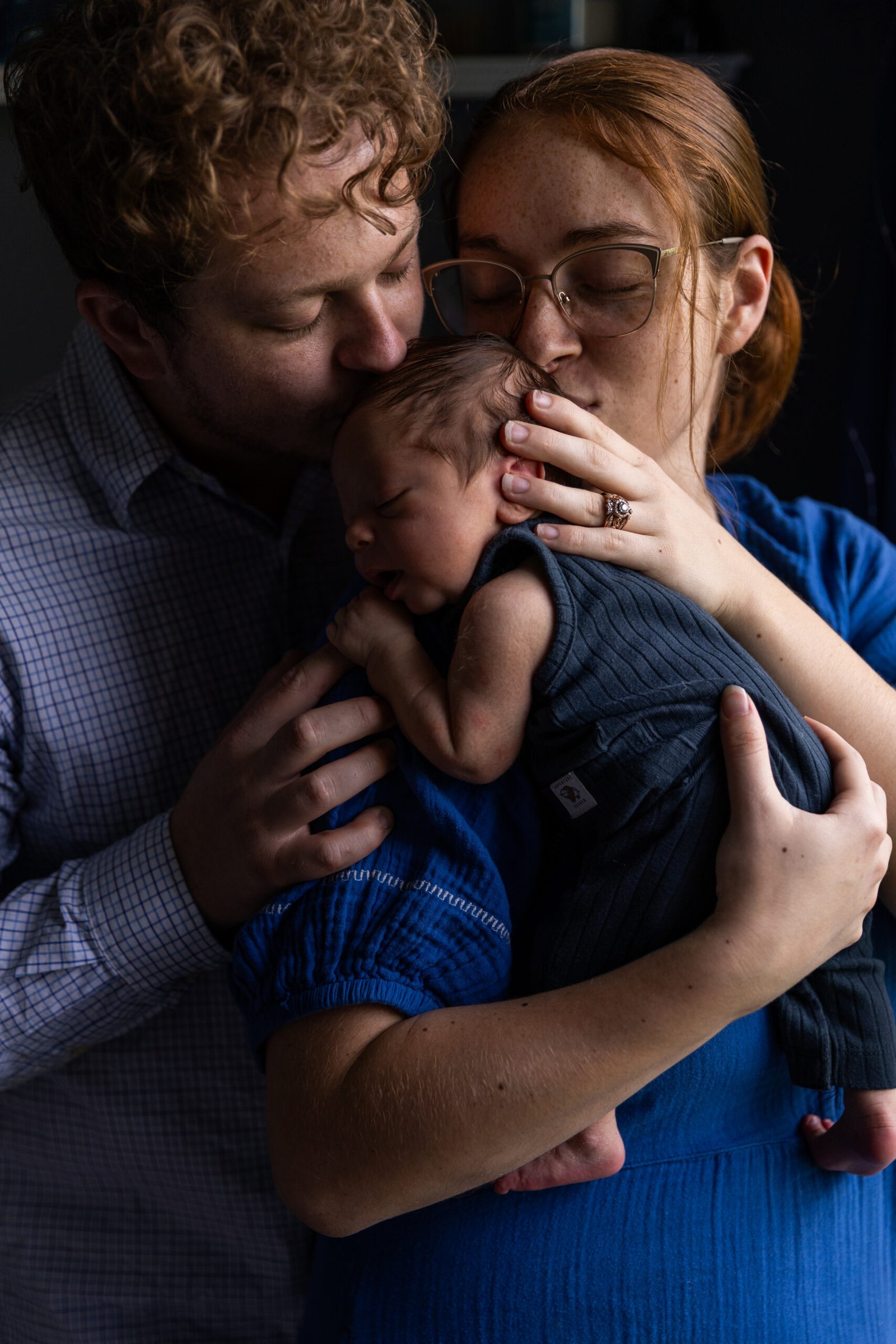 man and women holding a newborn baby